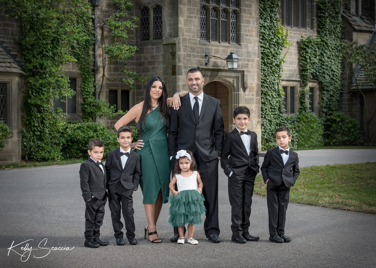family of seven outdoor formal portrait at the Edsel Ford mansion all standing in front