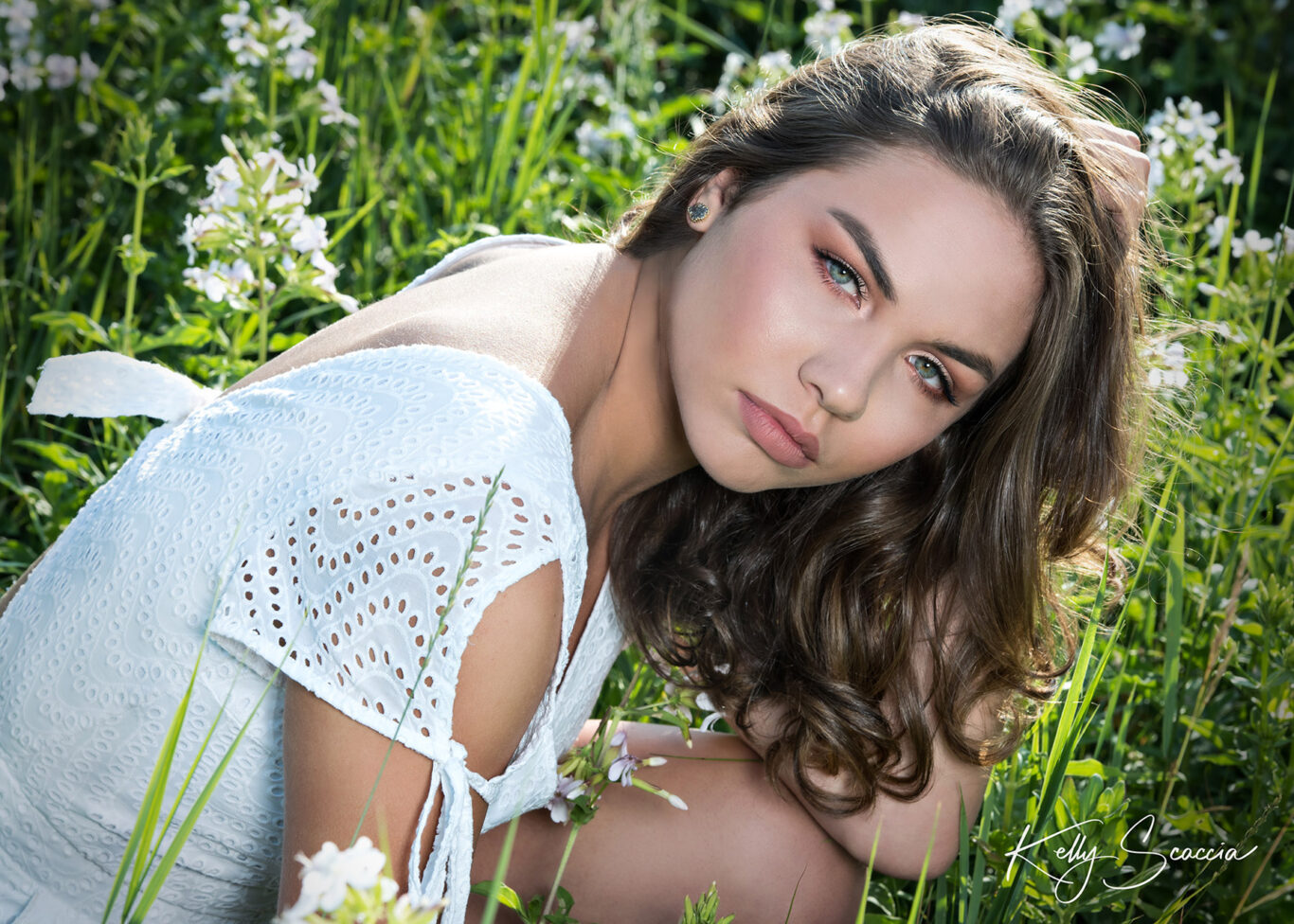 High School senior girl outdoor in a field wearing white up close headshot