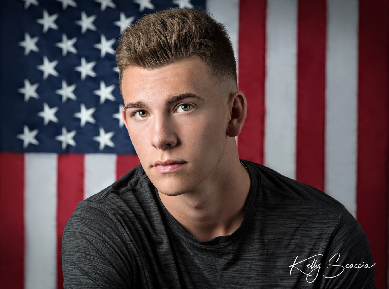 High School senior guy in studio portrait in front of the United States of America flag
