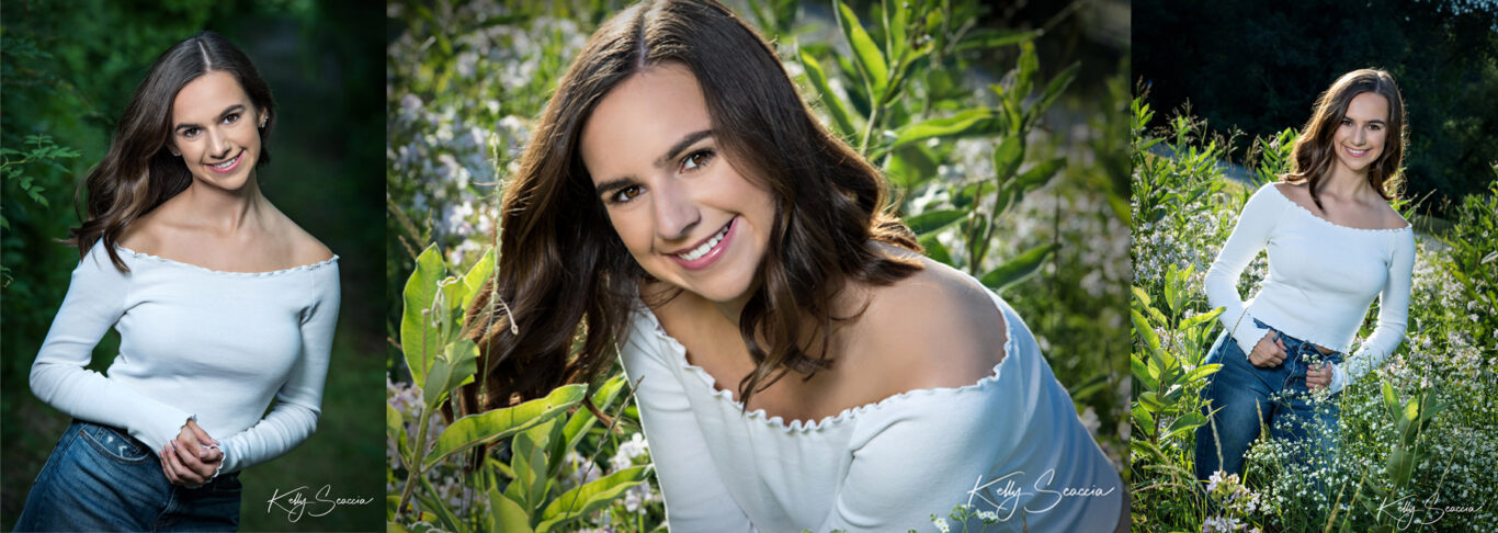 High School senior girl wearing white in a field of flowers smiling