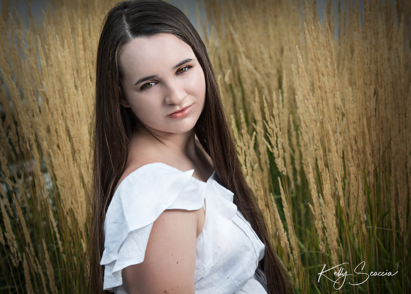 High School senior girl in wheat field up close